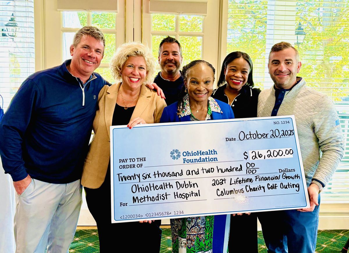 Presenting a check to a community hospital partner